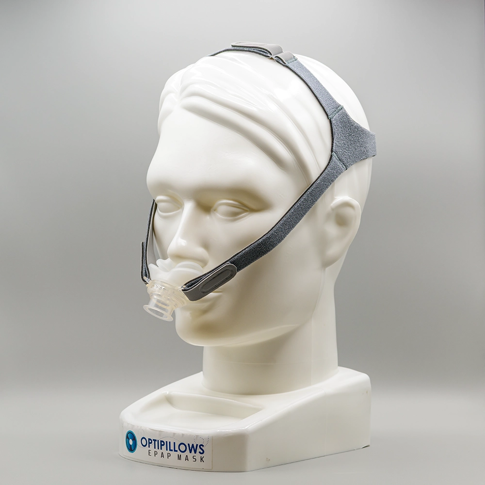 Opti+ MiniPAP mask worn on a model — the OptiPillows EPAP nasal-pillow mask with headgear