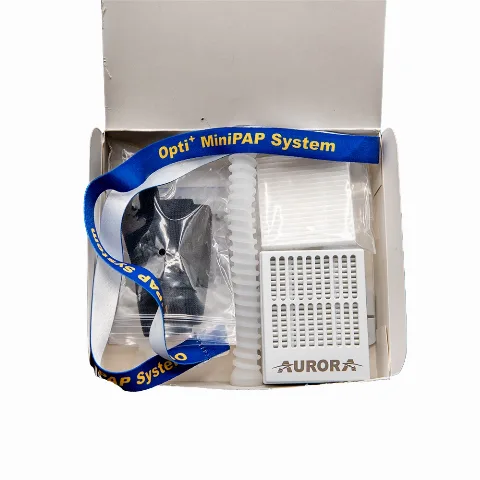 The complete Opti+ MiniPAP System kit in its box — nasal-pillow mask, headgear, hose, and the AURORA battery-powered air blower